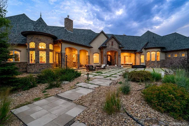 a front view of house with a garden