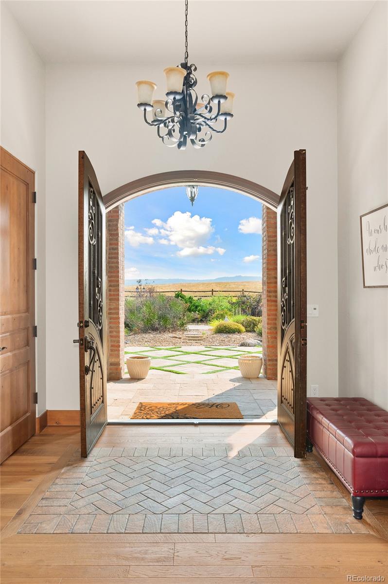 5740 Lambert Ranch Trail Sedalia, CO 80135 - Photo 5 of 48 a view of a livingroom with a furniture wooden floor and a chandelier