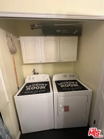 a kitchen with a stove and white cabinets