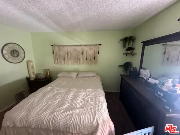 a bedroom with a bed and a table in it