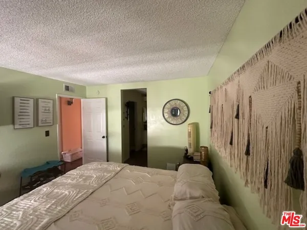 a bedroom with a bed and a cabinets