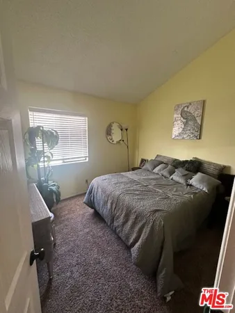 a bedroom with a bed and a chair