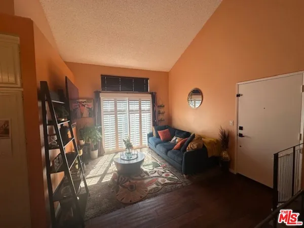 a living room with furniture a window and gym equipment