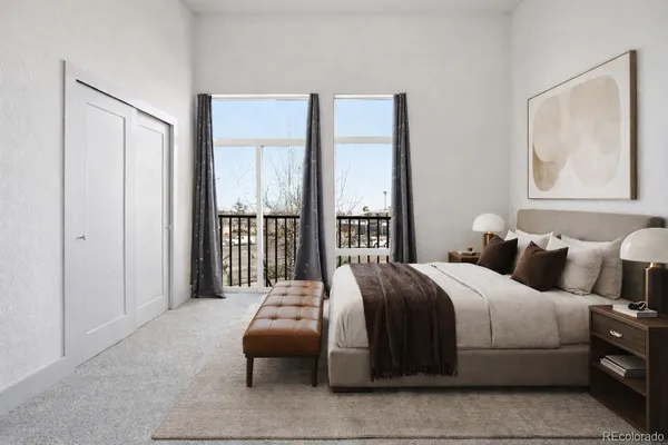 a bedroom with a bed and a painting on the wall