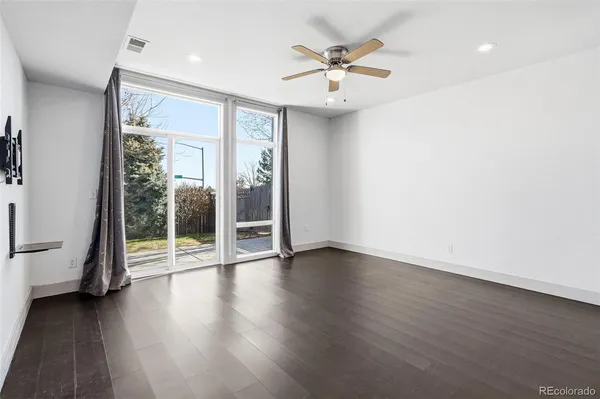 an empty room with wooden floor and door