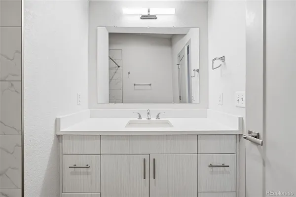 a bathroom with a sink and a mirror