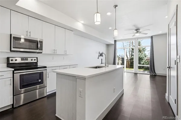 a kitchen with a stove a sink and a microwave