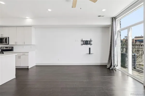 a view of empty room with wooden floor and windows