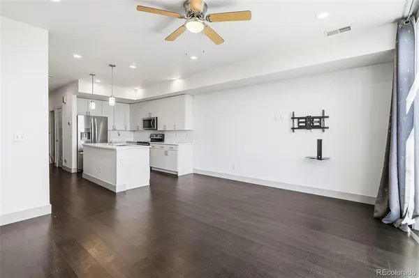 a view of a kitchen with cabinets and wooden floor
