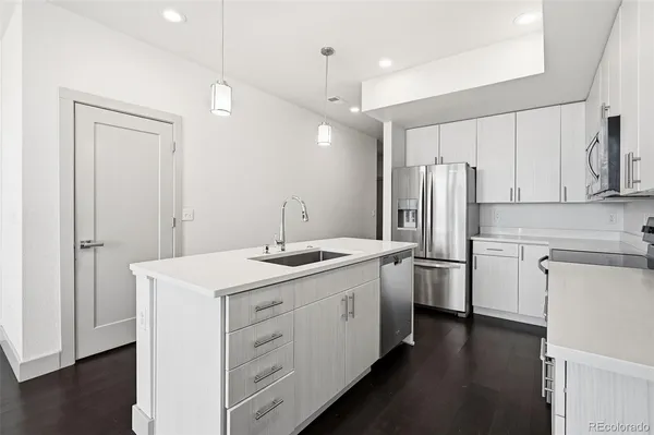 a kitchen with refrigerator cabinets and wooden floor