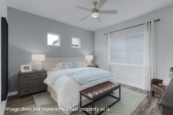 a bedroom with a bed window and a table