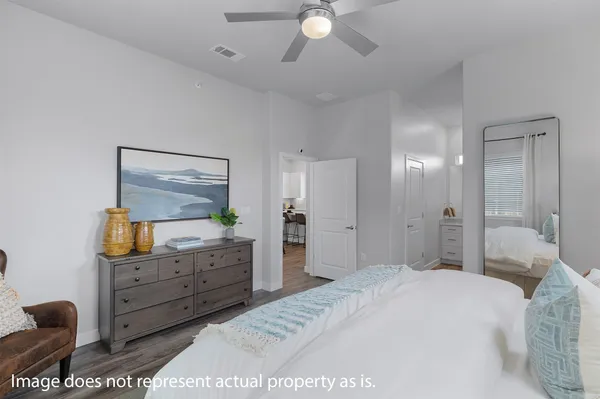 a bedroom with a bed and a dresser