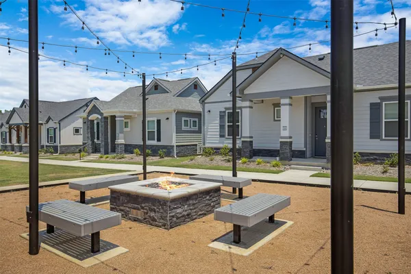 a view of a patio with a table and chairs