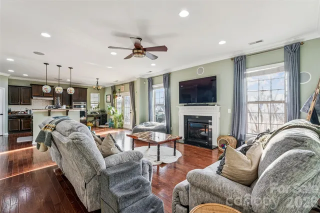 a living room with furniture fireplace and a flat screen tv