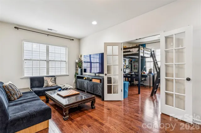a living room with furniture a rug and a window