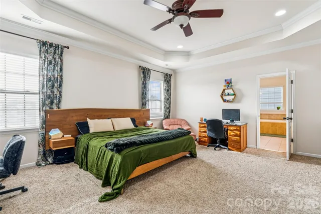 a bedroom with a bed and a chandelier