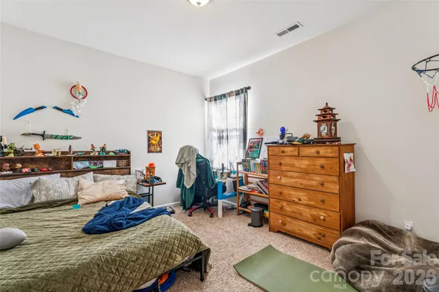 a bedroom with a bed and a couch