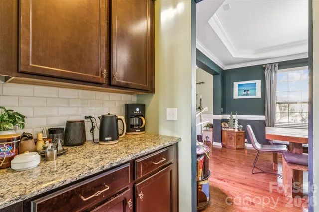 a kitchen with granite countertop a sink and cabinets