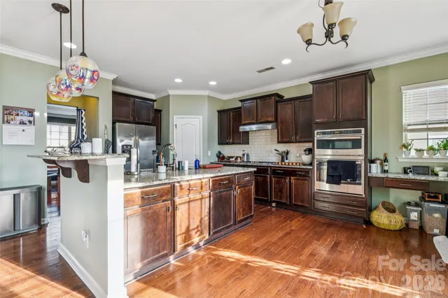 a kitchen with kitchen island granite countertop stainless steel appliances and counter space