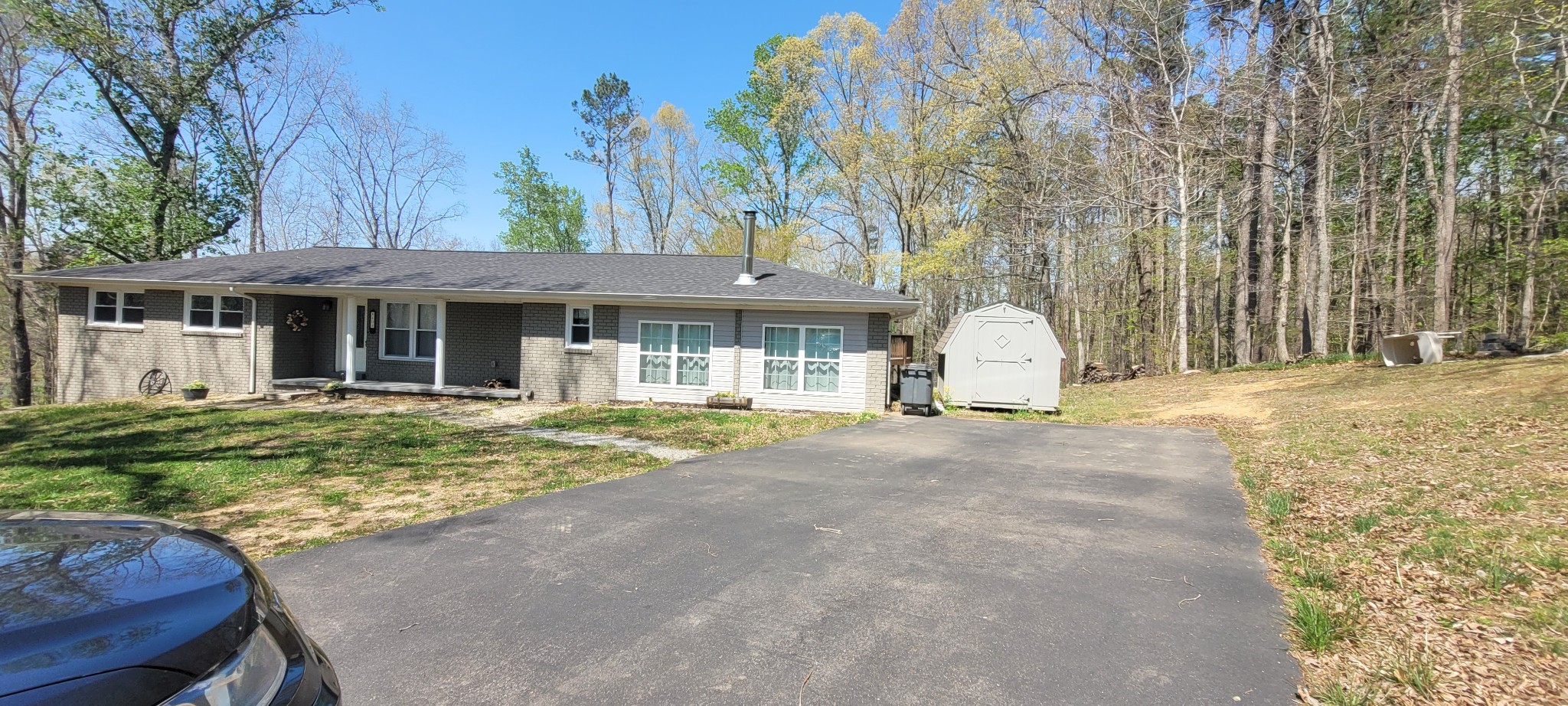 408 Sandy Road Dover, TN 37058 - Photo 25 of 32 a view of a white house with a large tree and wooden fence