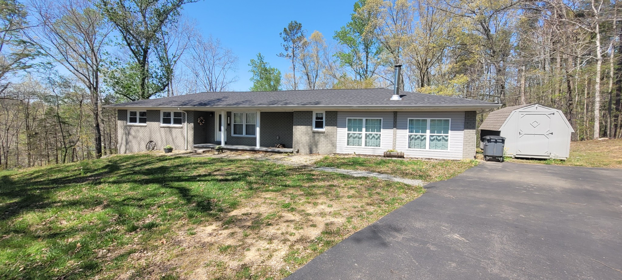 408 Sandy Road Dover, TN 37058 - Photo 30 of 32 a front view of a house with a garden