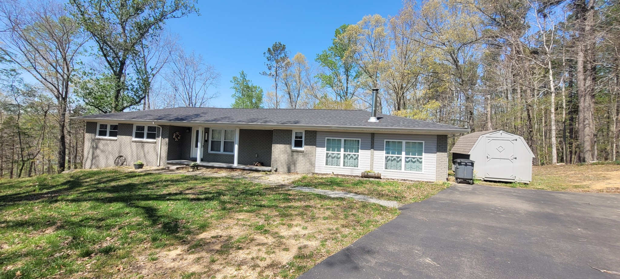 408 Sandy Road Dover, TN 37058 - Photo 32 of 32 a front view of a house with a garden and trees