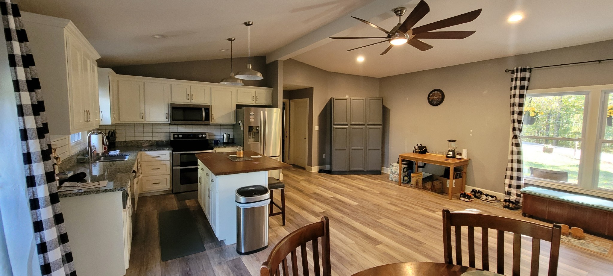 408 Sandy Road Dover, TN 37058 - Photo 6 of 32 a kitchen that has a refrigerator a stove a sink dishwasher a dining table and chairs with wooden floor