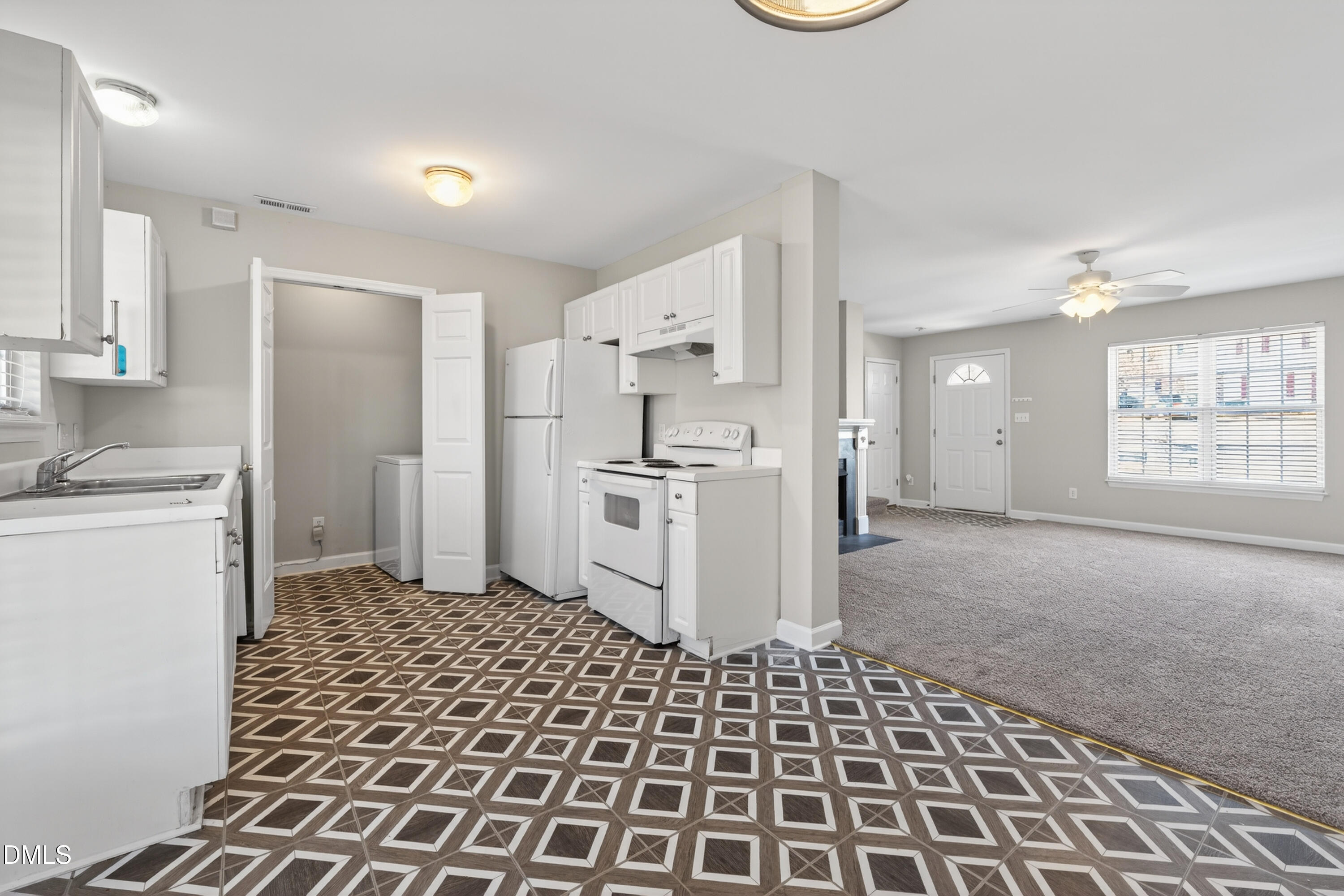 1601 Briarmont Court Raleigh, NC 27610 - Photo 11 of 30 a kitchen with a refrigerator a stove top oven and a sink