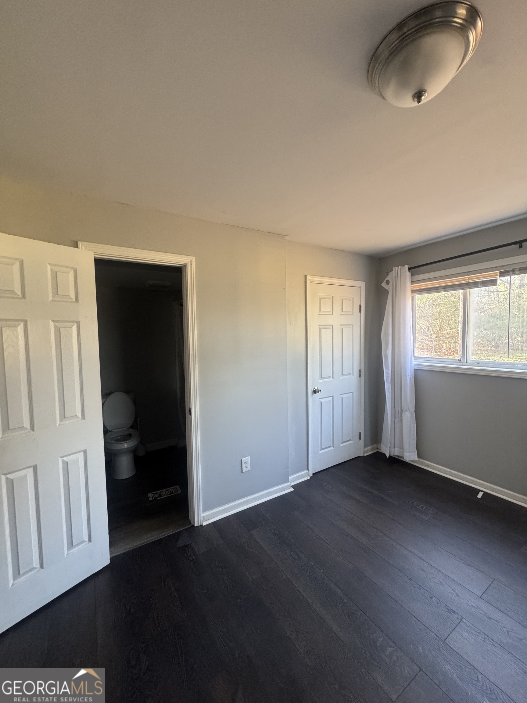 5205 Heather Lane Atlanta, GA 30349 - Photo 13 of 14 an empty room with wooden floor and windows