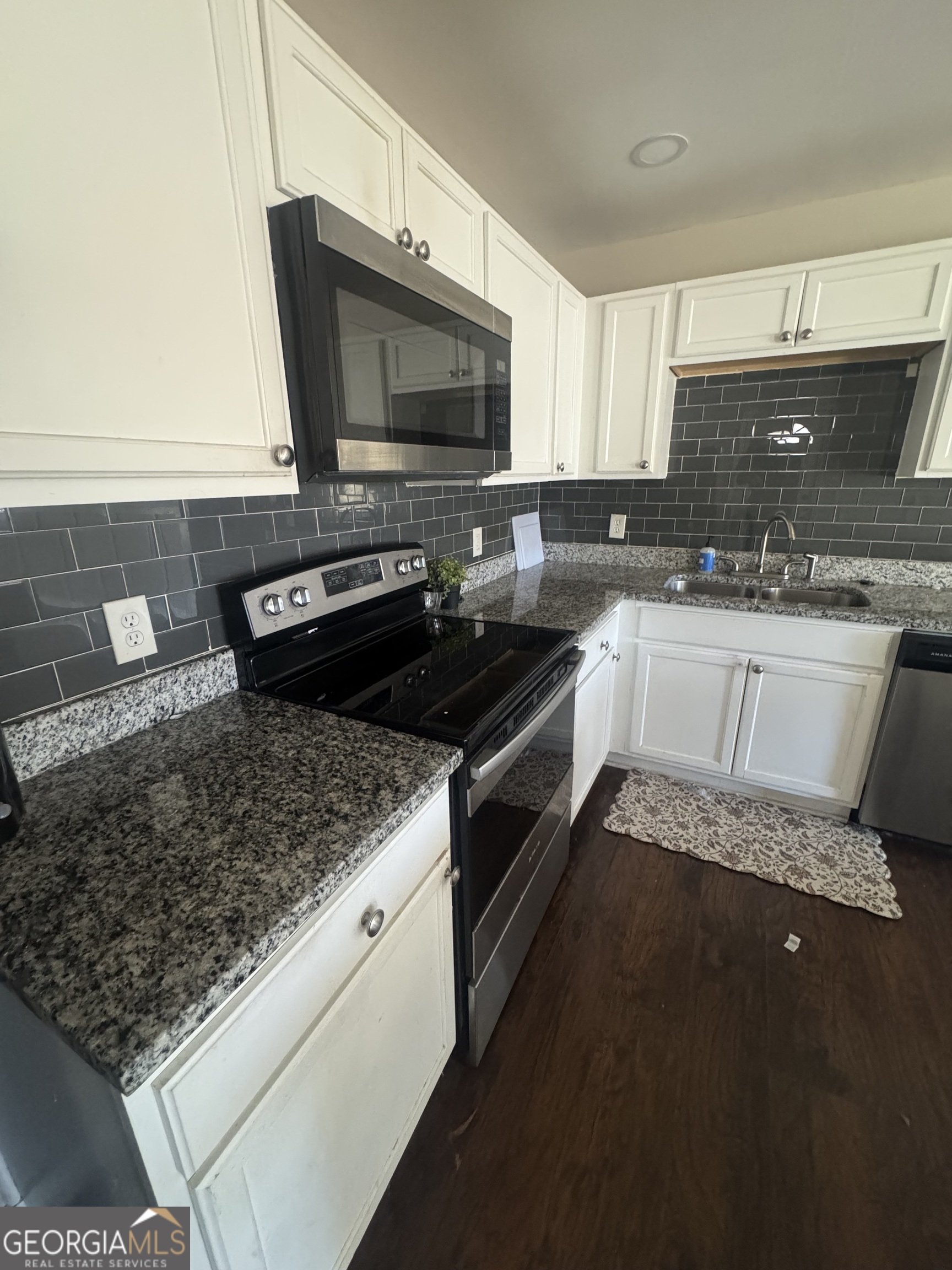 5205 Heather Lane Atlanta, GA 30349 - Photo 10 of 14 a kitchen with a stove and a microwave
