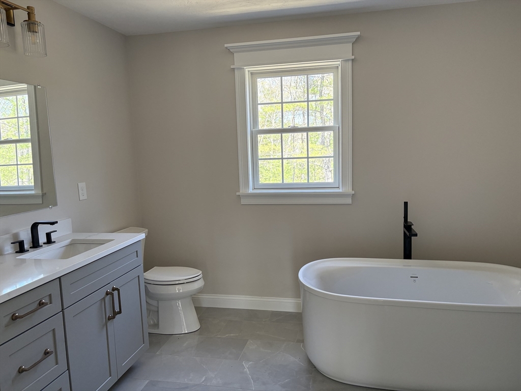 Lot 46 Rebecca Road Whitinsville, MA 01588 - Photo 11 of 13 a bathroom with a granite countertop sink a toilet and a window