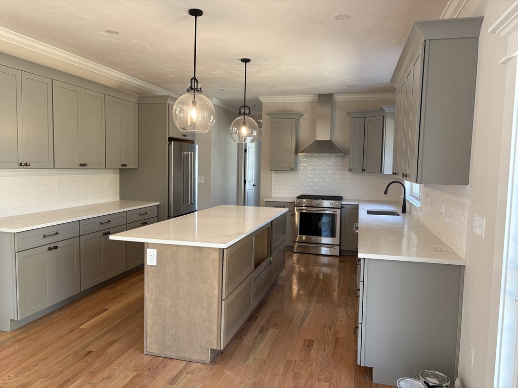 Lot 46 Rebecca Road Whitinsville, MA 01588 - Photo 6 of 13 a kitchen with stainless steel appliances granite countertop a sink a stove and a wooden floors
