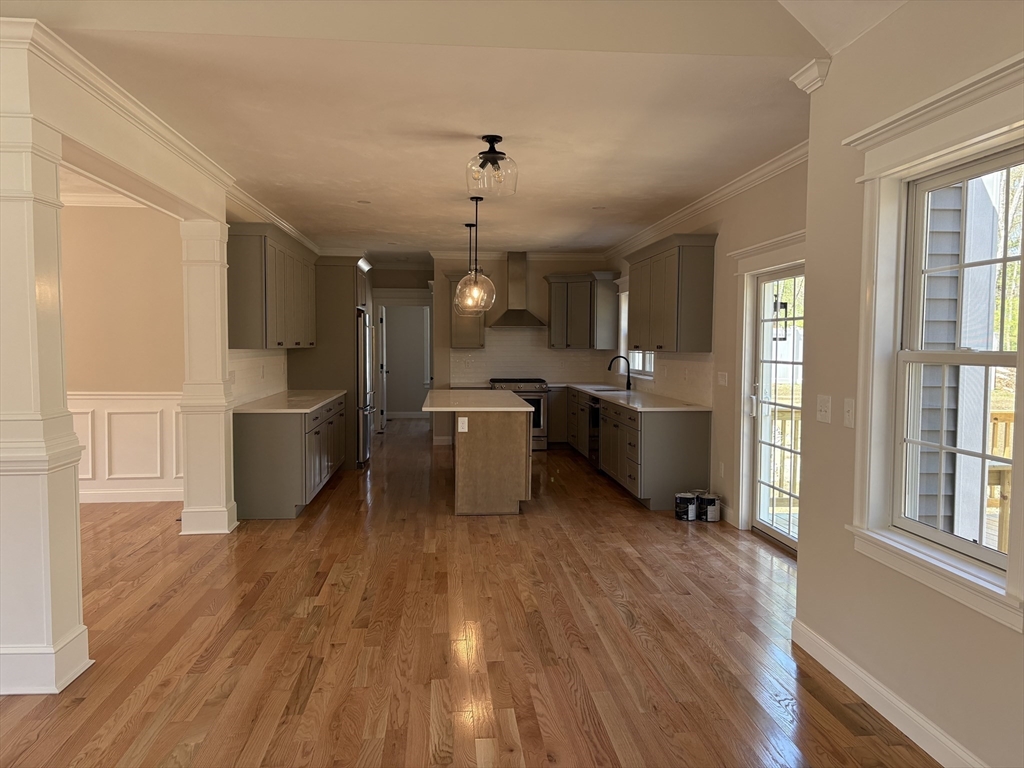 Lot 46 Rebecca Road Whitinsville, MA 01588 - Photo 7 of 13 a kitchen with stainless steel appliances kitchen island wooden floors stove and cabinets