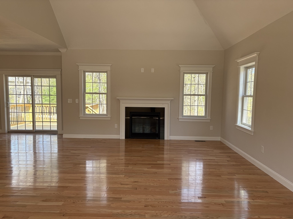 Lot 46 Rebecca Road Whitinsville, MA 01588 - Photo 8 of 13 an empty room with wooden floor and fireplace