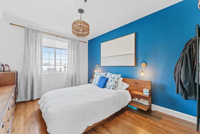 a bedroom with a bed and a chandelier