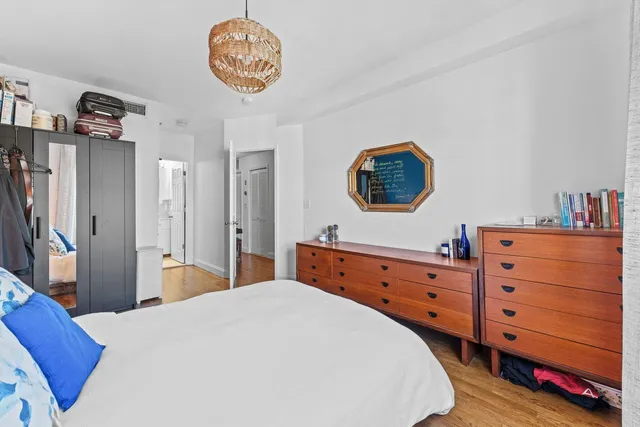 a bedroom with a bed and a dresser