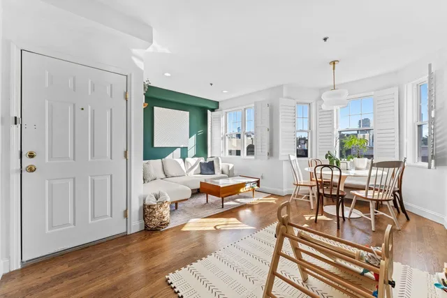 a living room with furniture or couch and a chandelier