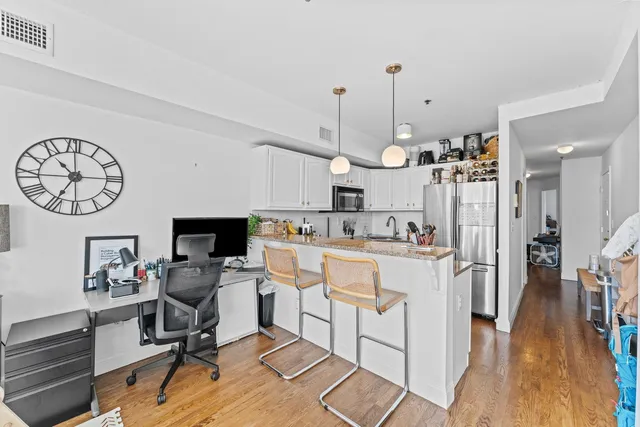 a view of kitchen with cabinets and wooden floor