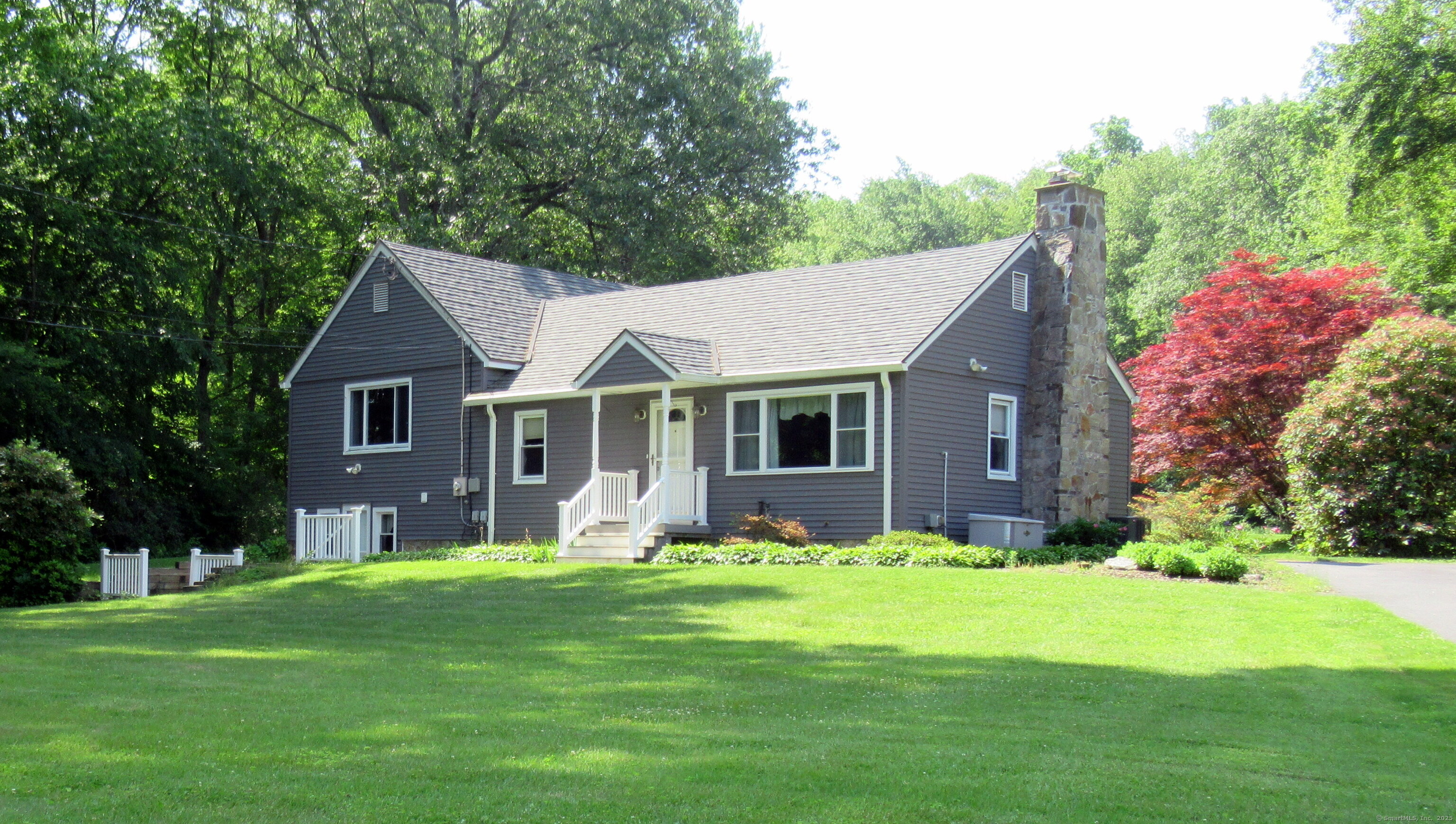 37 Watrous Road Bolton, CT 06043 - Photo 1 of 1 a front view of a house with garden and trees