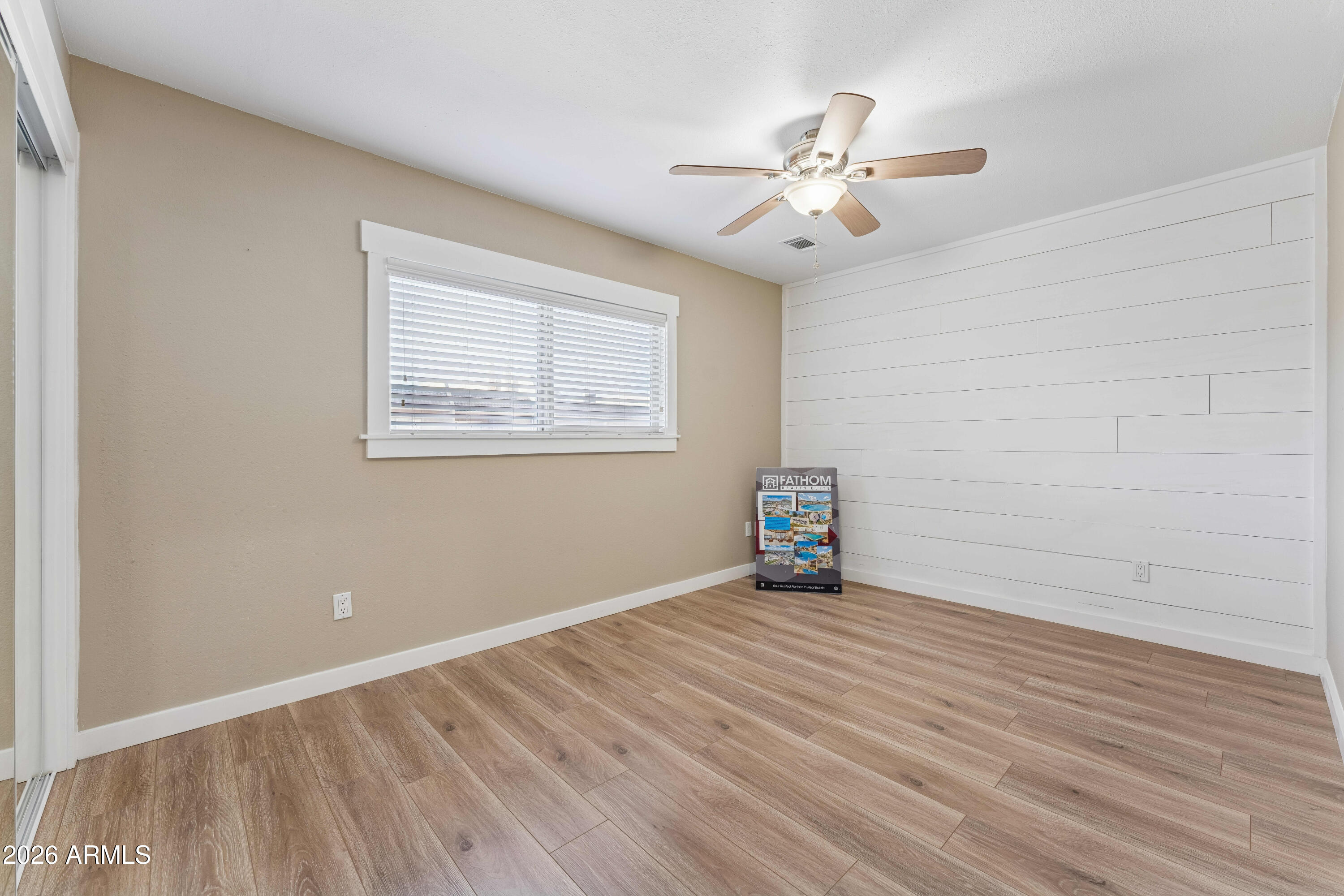 7436 East Chaparral Road, Unit B258 Scottsdale, AZ 85250 - Photo 12 of 23 a view of an empty room with wooden floor and a window