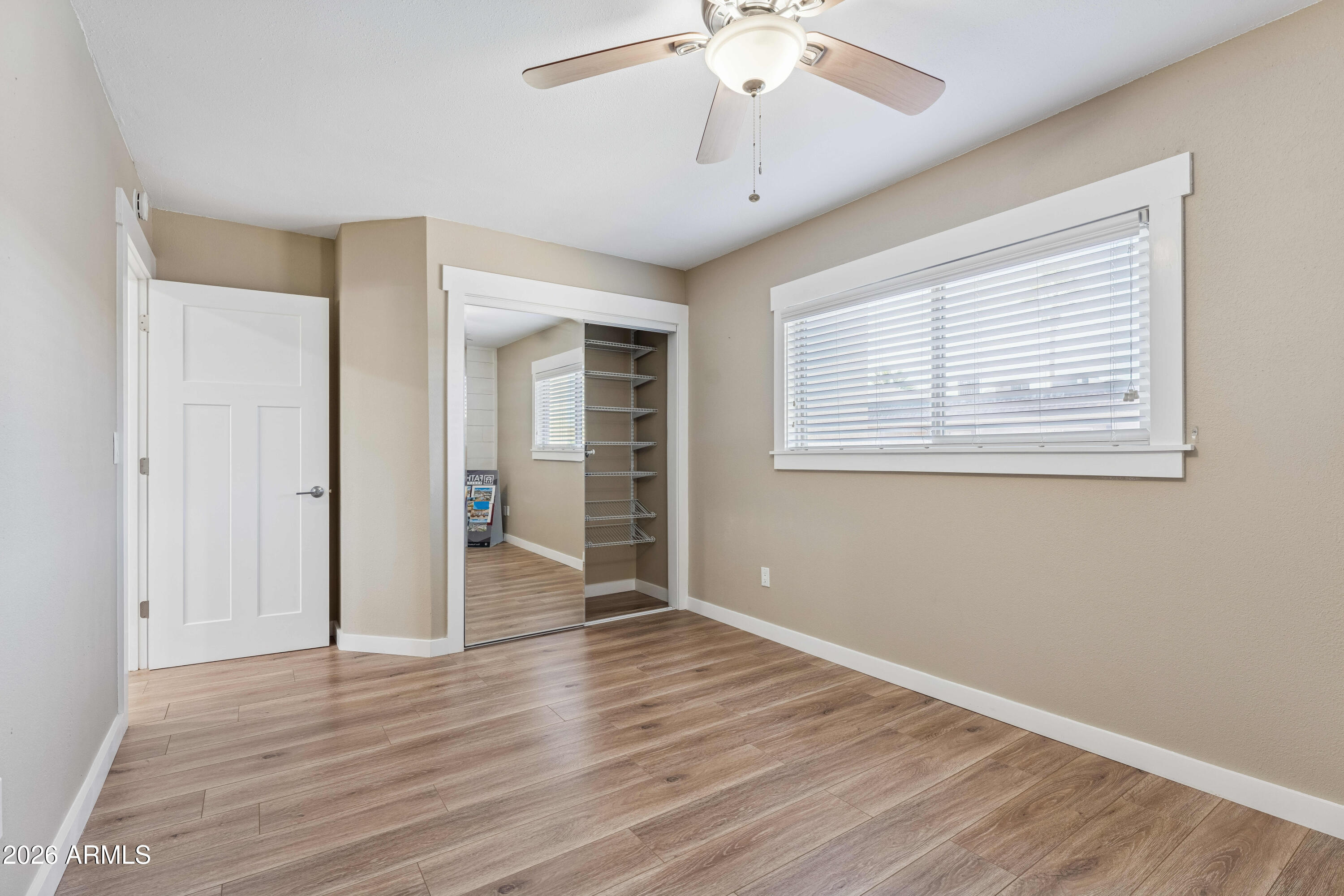 7436 East Chaparral Road, Unit B258 Scottsdale, AZ 85250 - Photo 13 of 23 a view of an empty room with wooden floor and a window