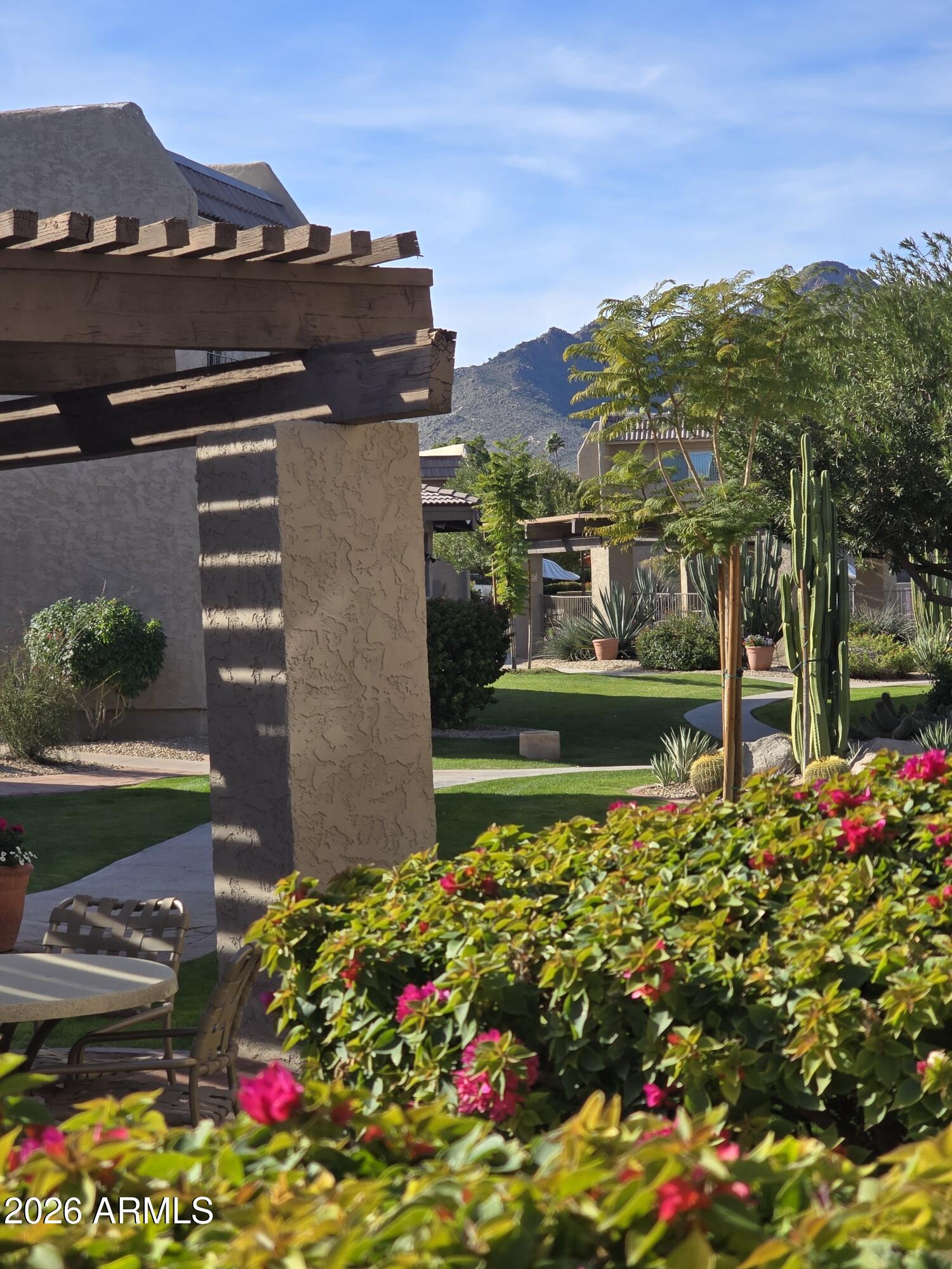 7436 East Chaparral Road, Unit B258 Scottsdale, AZ 85250 - Photo 17 of 23 a view of a house with a yard and garden