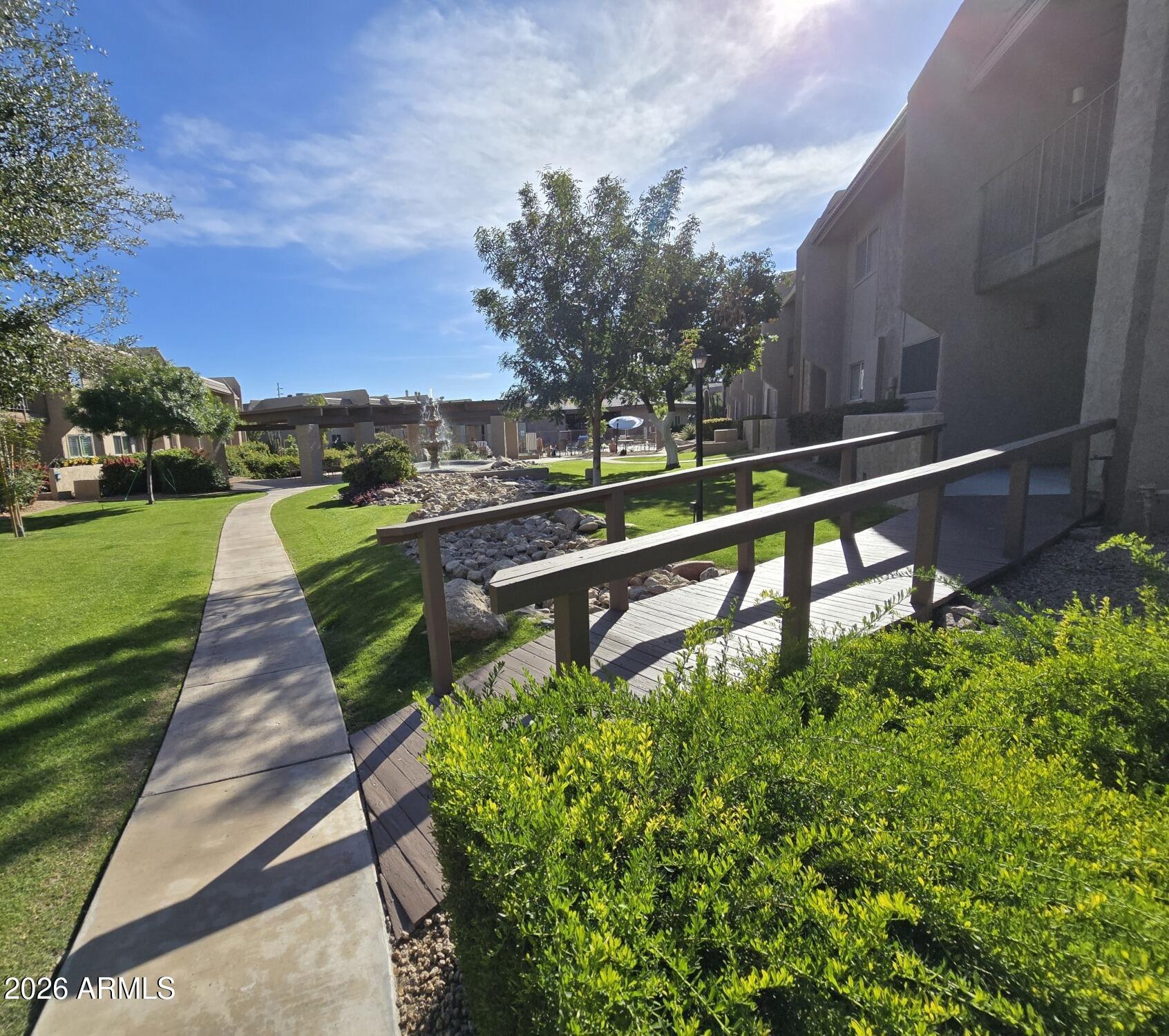 7436 East Chaparral Road, Unit B258 Scottsdale, AZ 85250 - Photo 19 of 23 a swimming pool with outdoor seating and garden