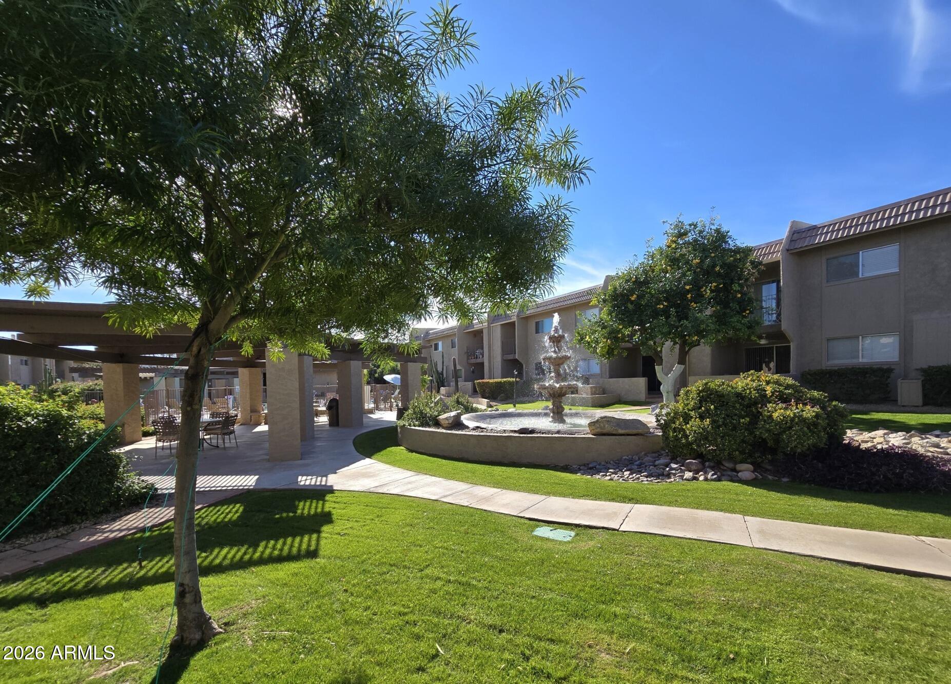 7436 East Chaparral Road, Unit B258 Scottsdale, AZ 85250 - Photo 23 of 23 a front view of a house with a yard table and chairs