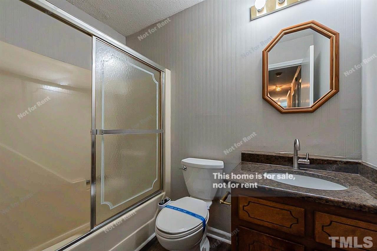 525 Rand Road Raleigh, NC 27603 - Photo 11 of 14 a bathroom with a toilet a sink and mirror