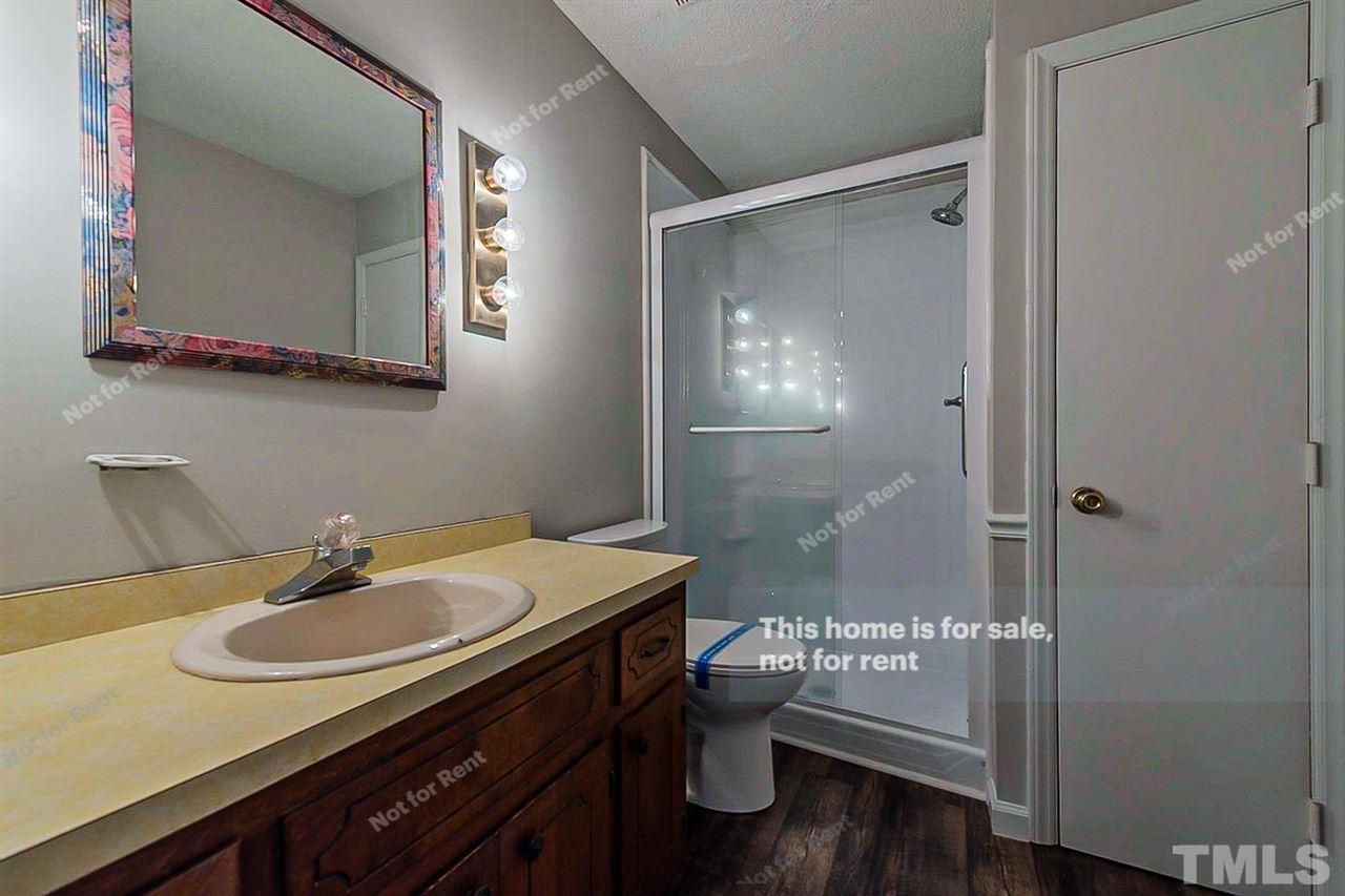 525 Rand Road Raleigh, NC 27603 - Photo 4 of 14 a bathroom with a sink and a mirror