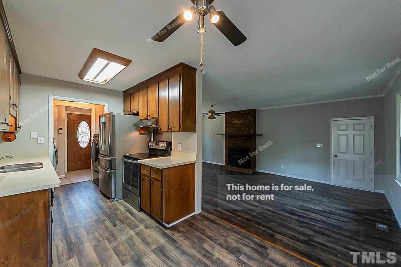 525 Rand Road Raleigh, NC 27603 - Photo 6 of 14 a open kitchen with stainless steel appliances granite countertop a stove and a wooden floors