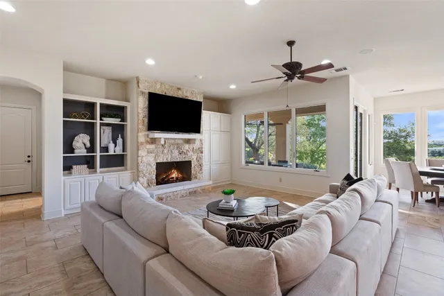 a living room with furniture a fireplace and a flat screen tv
