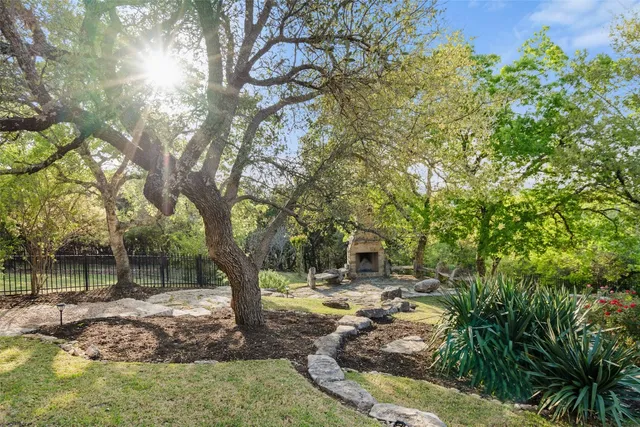 a backyard of a house with table and chairs