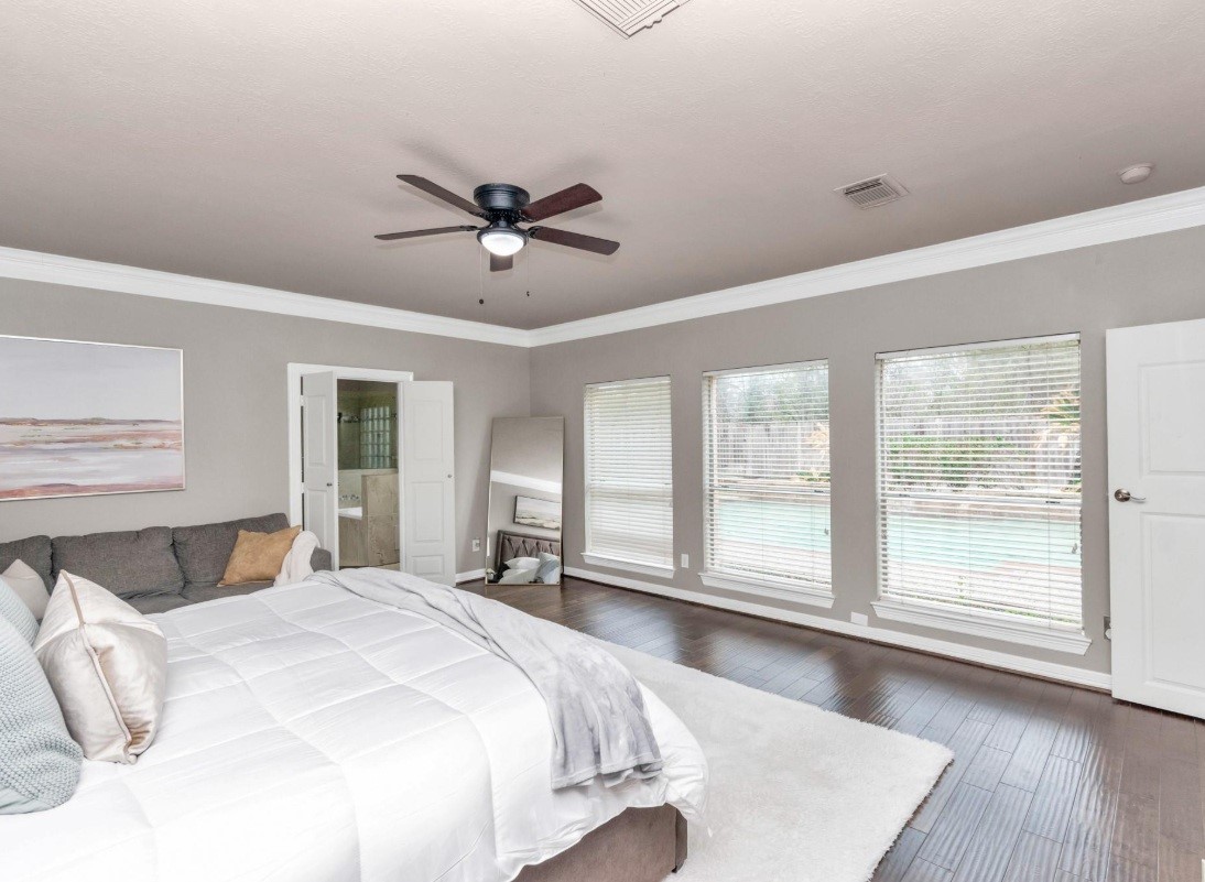 16522 Champions Cove Circle Spring, TX 77379 - Photo 18 of 30 a bedroom with a large bed and a large window